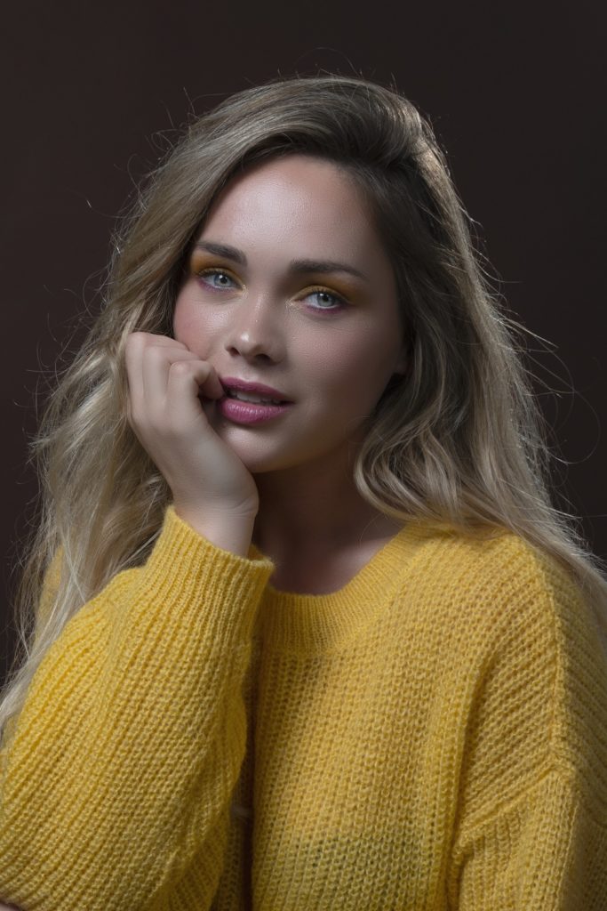 Beauty photography blue eyes and yellow sweater with yellow and pink eyehadow