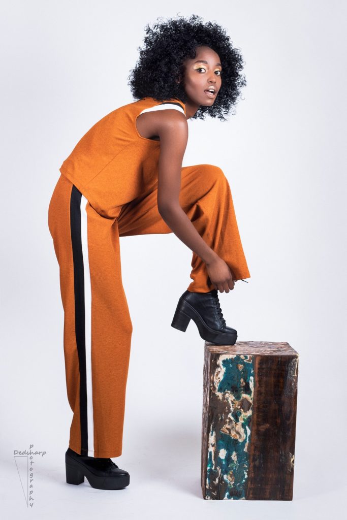 Fashion photo shoot girl in orange jumpsuit